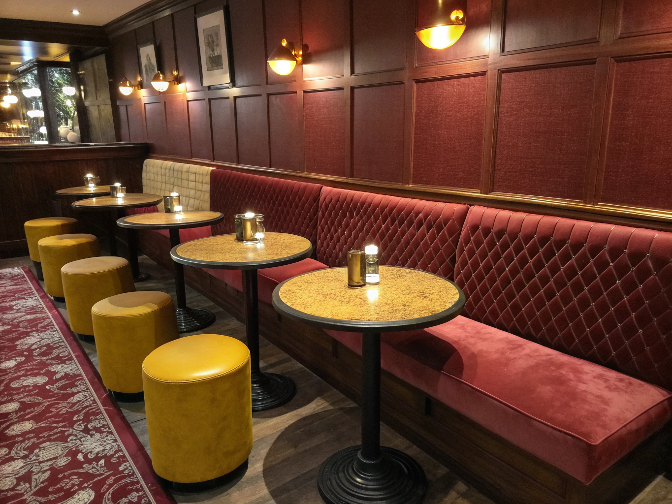 Plush velvet banquette seating with ambient candlelight